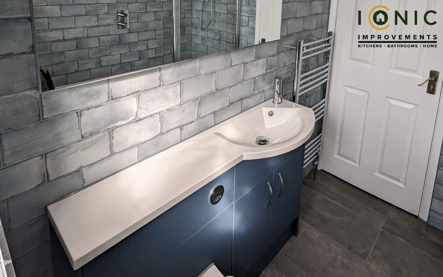 Modern bathroom installation by Iconic Improvements, featuring sleek fixtures and stylish tiles